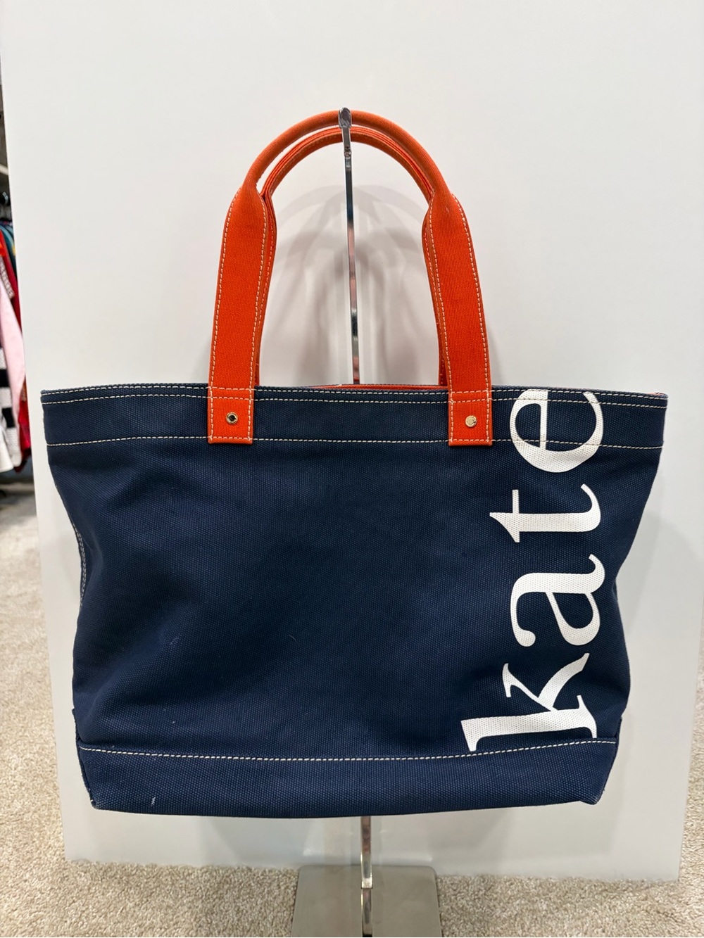 kate spade navy canvas tote with orange handles and white logo